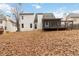 Exterior of home featuring a screened in porch, and deck, with a view of the yard covered in leaves at 3119 Blue Heron Pass, Powder Springs, GA 30127