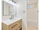 Bright bathroom featuring a modern vanity, mirror, and a tub shower with tiled walls at 3119 Blue Heron Pass, Powder Springs, GA 30127