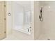 Luxury bathroom with a soaking tub, stand-up shower, and white marble tiling throughout at 3119 Blue Heron Pass, Powder Springs, GA 30127