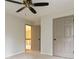 Carpeted bedroom with two closets, ceiling fan, and entry leading to the stairway at 3119 Blue Heron Pass, Powder Springs, GA 30127