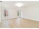 Bright bedroom with light hardwood floors, neutral paint, and large windows with wooded views at 3119 Blue Heron Pass, Powder Springs, GA 30127