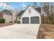 Exterior view of home showing two-car garage and well-maintained driveway at 3119 Blue Heron Pass, Powder Springs, GA 30127