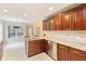 Modern kitchen with dark wood cabinets, stainless appliances, and white countertops and backsplash at 3119 Blue Heron Pass, Powder Springs, GA 30127