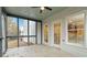 An outdoor screened porch with a ceiling fan, white walls, and access to the outdoors and views of the surrounding landscape at 3119 Blue Heron Pass, Powder Springs, GA 30127