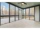 Large screened porch with stone floors, lots of windows, and a ceiling fan at 3119 Blue Heron Pass, Powder Springs, GA 30127