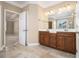 Bright bathroom featuring a double vanity, tile flooring, and a view into the bedroom at 407 Trotters Run, Woodstock, GA 30188