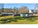 Expansive backyard featuring multiple outbuildings, RV parking, and lush green lawn at 5320 Karr Rd, Cumming, GA 30040