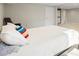 A spacious carpeted basement bedroom with a stylish bed, lounge chair, and ample natural light at 5320 Karr Rd, Cumming, GA 30040