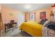 Bright bedroom with salmon-colored walls and a large window with a view of the backyard at 5320 Karr Rd, Cumming, GA 30040
