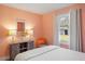 Bedroom with salmon-colored walls, white curtains, white bedding and a view of the backyard at 5320 Karr Rd, Cumming, GA 30040