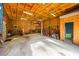 Spacious garage with plywood walls, work area, and door to another room at 5320 Karr Rd, Cumming, GA 30040