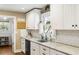 Well-lit kitchen featuring granite countertops, white cabinets, and subway tile backsplash at 5320 Karr Rd, Cumming, GA 30040