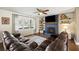 Spacious living room featuring wood floors, a fireplace, and natural light from large windows at 5320 Karr Rd, Cumming, GA 30040