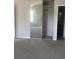 Bedroom showcasing a built-in closet with sliding mirror door and neutral carpet at 5626 Pine Gate Dr, Atlanta, GA 30349