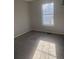 Bedroom featuring a window with natural light and neutral colored walls at 5626 Pine Gate Dr, Atlanta, GA 30349
