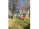 Front exterior of two-story home featuring a lawn and mature trees at 5626 Pine Gate Dr, Atlanta, GA 30349