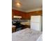 Traditional kitchen with wooden cabinets, and white refrigerator at 5626 Pine Gate Dr, Atlanta, GA 30349
