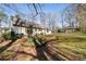 Exterior shot of the back of the home showing a large backyard with foliage at 1140 Goodwin Ne Pl, Atlanta, GA 30319