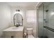 Updated bathroom with modern vanity, framed mirror, and tiled shower with glass door at 1140 Goodwin Ne Pl, Atlanta, GA 30319