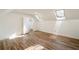 Bright bedroom features two skylights, light-colored hardwood floors, and an open door to the ensuite bathroom at 1140 Goodwin Ne Pl, Atlanta, GA 30319