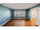 Charming bedroom featuring light blue walls, hardwood flooring, large windows, and white trim at 1140 Goodwin Ne Pl, Atlanta, GA 30319