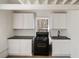 Bright updated kitchen with modern white cabinetry, black countertops, and stainless steel sink at 1140 Goodwin Ne Pl, Atlanta, GA 30319