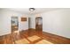 Open-concept living area featuring hardwood floors and access to the kitchen and entryway at 1140 Goodwin Ne Pl, Atlanta, GA 30319