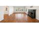 Spacious living room with hardwood floors, a large window, and a fireplace with a dark mantel at 1140 Goodwin Ne Pl, Atlanta, GA 30319