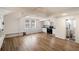 Bright open concept living room featuring wood floors, exposed beams, kitchen, and full bathroom at 1140 Goodwin Ne Pl, Atlanta, GA 30319