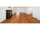 Open living room with hardwood floors, fireplace, and multiple doorways to other rooms at 1140 Goodwin Ne Pl, Atlanta, GA 30319