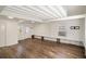 Large open concept living room featuring wood floors, painted brick details, and access to the exterior at 1140 Goodwin Ne Pl, Atlanta, GA 30319