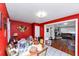 Bright dining room area with red walls, tile floor and an open doorway to a living room with hardwood floors at 2754 Drew Valley Ne Rd, Atlanta, GA 30319