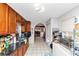 A kitchen with an arched doorway and a view of the living room, with wooden cabinets and a black counter top at 2754 Drew Valley Ne Rd, Atlanta, GA 30319