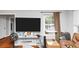 Living room with a large window, hardwood floors, and a mounted television at 2754 Drew Valley Ne Rd, Atlanta, GA 30319