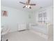 Light and airy bedroom with neutral carpet, a ceiling fan, and a window with white curtains at 1825 Embassy Walk Ln, Lilburn, GA 30047