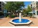 Beautiful outdoor plaza with blue tiled water fountain, seating, and restaurants with market umbrellas at 334 Olmstead Way # 37, Alpharetta, GA 30022