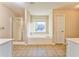Well-lit bathroom features a separate shower and soaking tub at 3510 Long Lake Dr, Douglasville, GA 30135