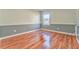 Empty bedroom showcasing the wood floors and natural light at 3510 Long Lake Dr, Douglasville, GA 30135