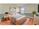 Cozy staged bedroom with wood floor, large bed, and ample natural light at 3510 Long Lake Dr, Douglasville, GA 30135