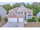 Traditional two-story brick and stucco home, featuring an attached two-car garage and manicured landscaping at 3510 Long Lake Dr, Douglasville, GA 30135