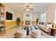 Staged living room with fireplace, ceiling fan, and white furniture at 3510 Long Lake Dr, Douglasville, GA 30135