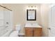 Cozy bathroom with shower/tub combo, wooden vanity, and a stylish framed mirror at 381 Warner Se, Marietta, GA 30060