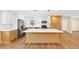 Bright kitchen boasts white cabinets, stainless appliances, and a large island at 381 Warner Se, Marietta, GA 30060