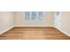 Bright living room featuring new hardwood floors, a large window, and fresh paint, ready for personalization at 381 Warner Se, Marietta, GA 30060