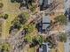 Aerial perspective of the house highlighting its backyard, mature trees, and proximity to neighboring properties at 610 Amberwood Pl, Euharlee, GA 30145