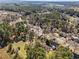 Wide aerial view of property in a suburban setting near forest with large acreage at 610 Amberwood Pl, Euharlee, GA 30145