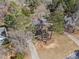 Aerial view of a home nestled among mature trees with a long driveway, showcasing its serene and private setting at 610 Amberwood Pl, Euharlee, GA 30145