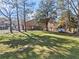 Expansive backyard featuring a well-maintained lawn and mature trees, ideal for outdoor activities and relaxation at 610 Amberwood Pl, Euharlee, GA 30145