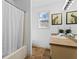 Bright bathroom featuring modern vanity, shower with curtain, and stylish decor at 610 Amberwood Pl, Euharlee, GA 30145
