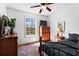 Bedroom with a window view of the trees, bed with furniture, and ceiling fan at 610 Amberwood Pl, Euharlee, GA 30145